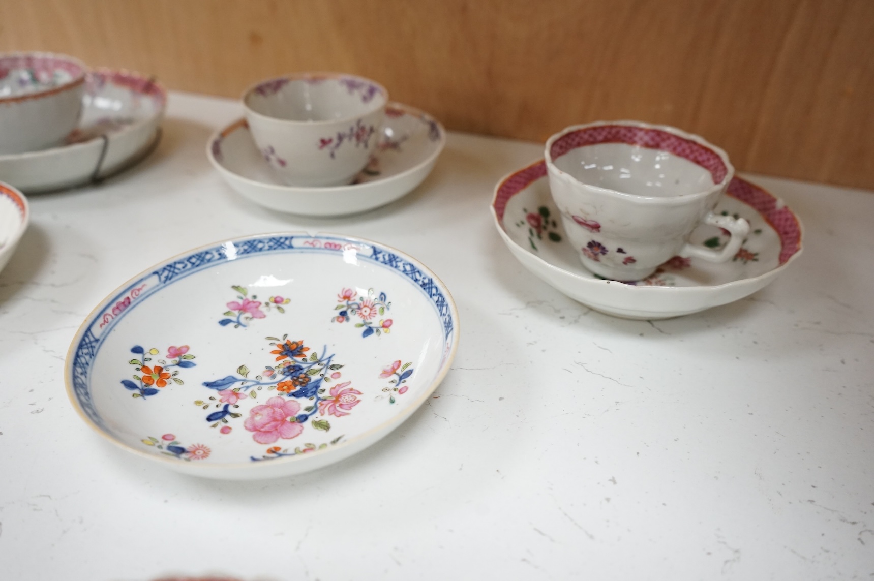 A collection of 18th century Chinese export and English porcelain to include tea bowls and saucers, largest saucer 14cm in diameter